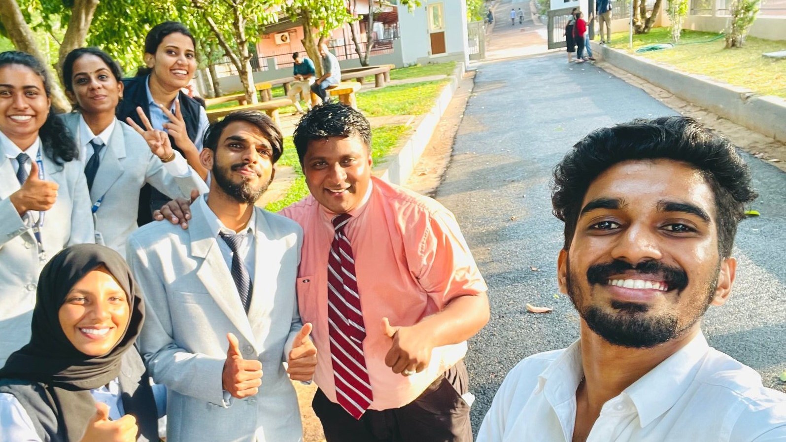 Suresh Natarajan with college students after a campus training session